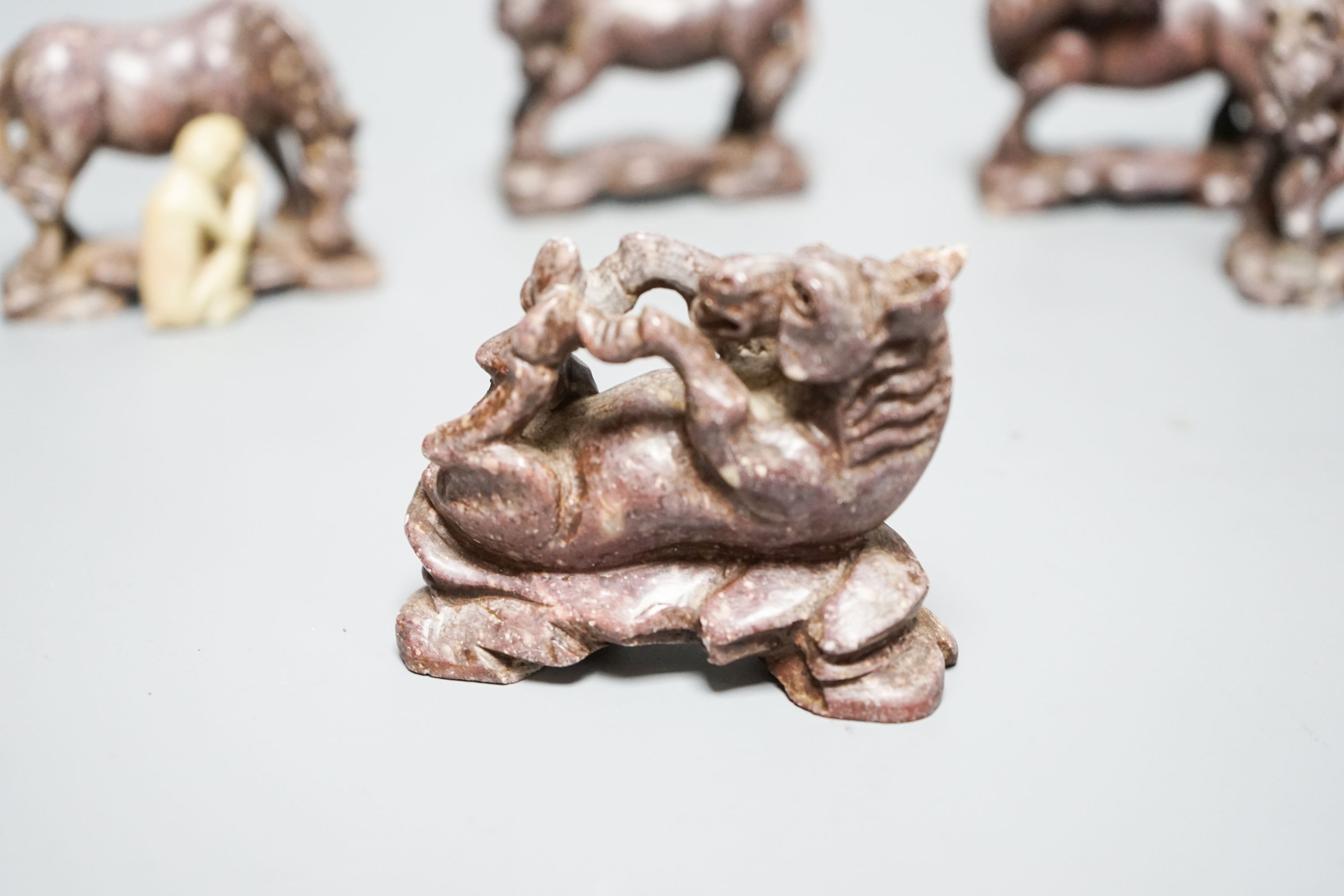 Six Chinese soapstone models of horses and a similar monkey, early 20th century